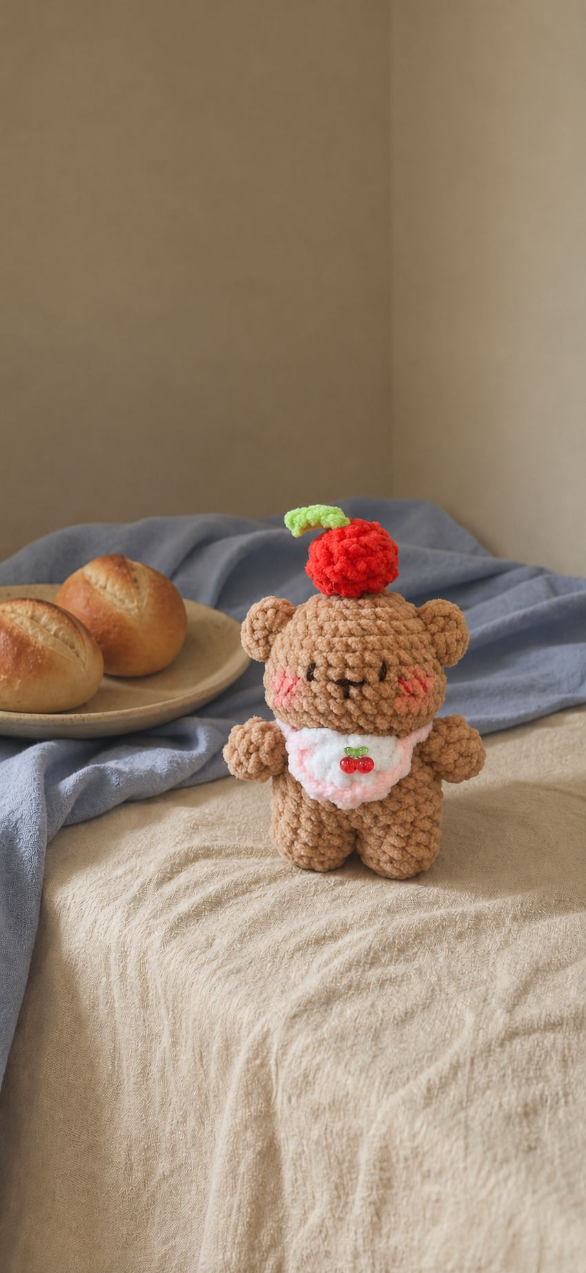 Brown crochet cherry bear with pink-edged bib
