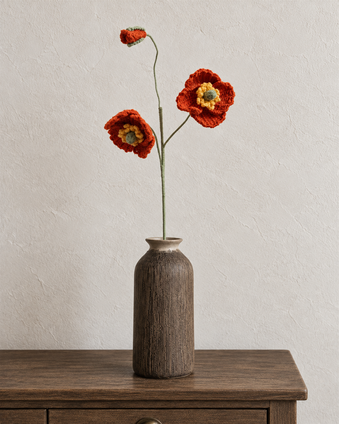 Rust red crochet poppy stem with two flowers and a bud; vase not included